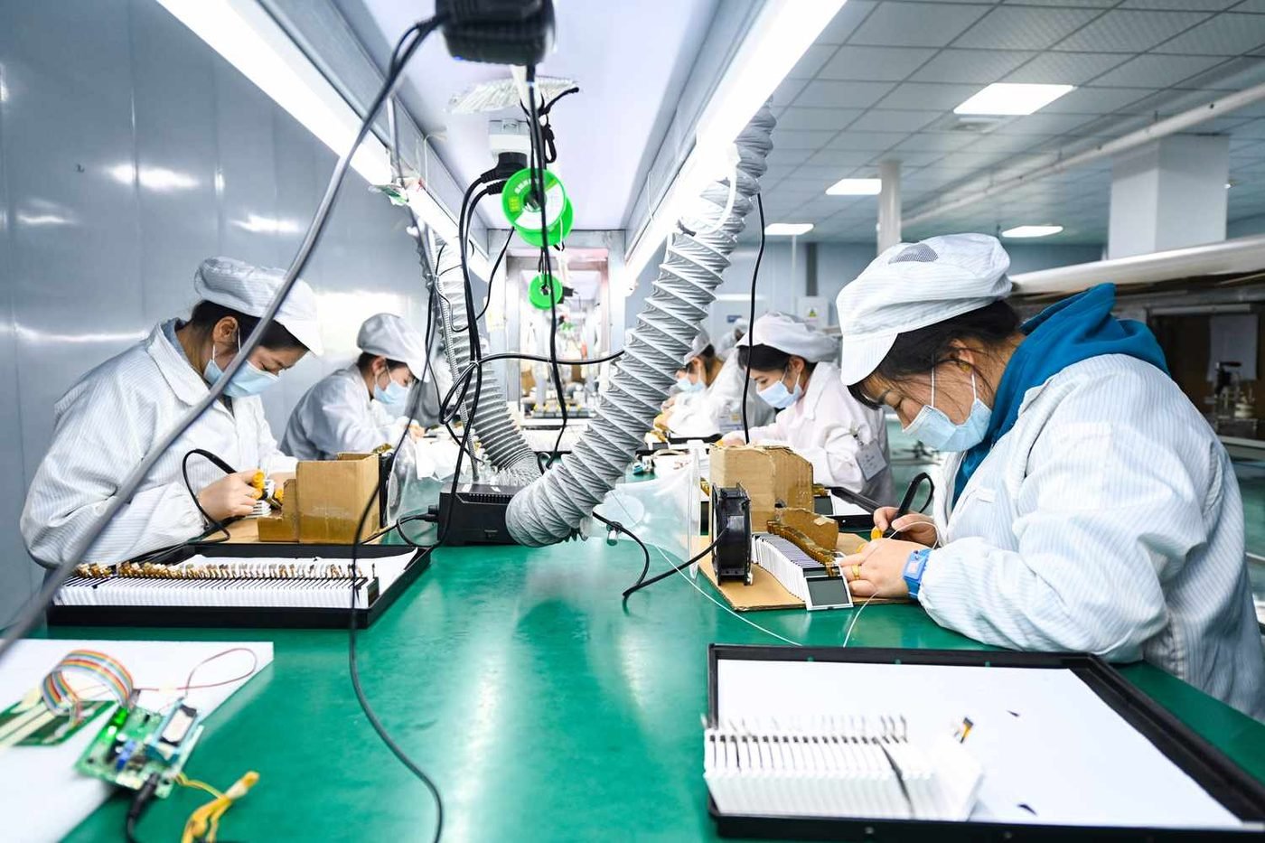Workers assembling electronics on a factory line in China