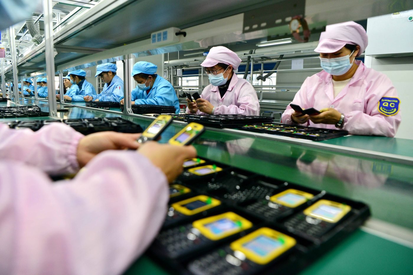 Quality control inspection on a Chinese factory production line